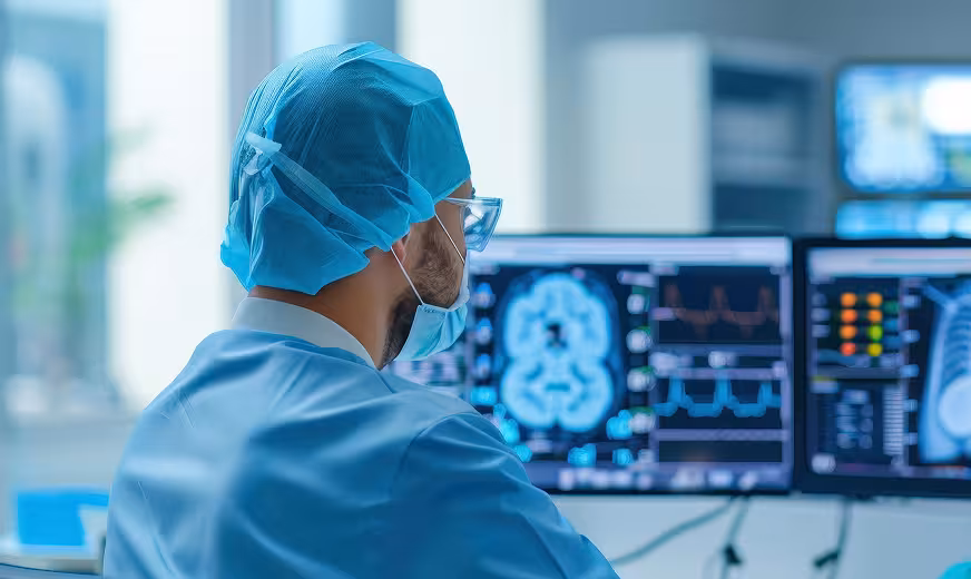 Doctor-examines-multiple-screens Man viewing x-ray