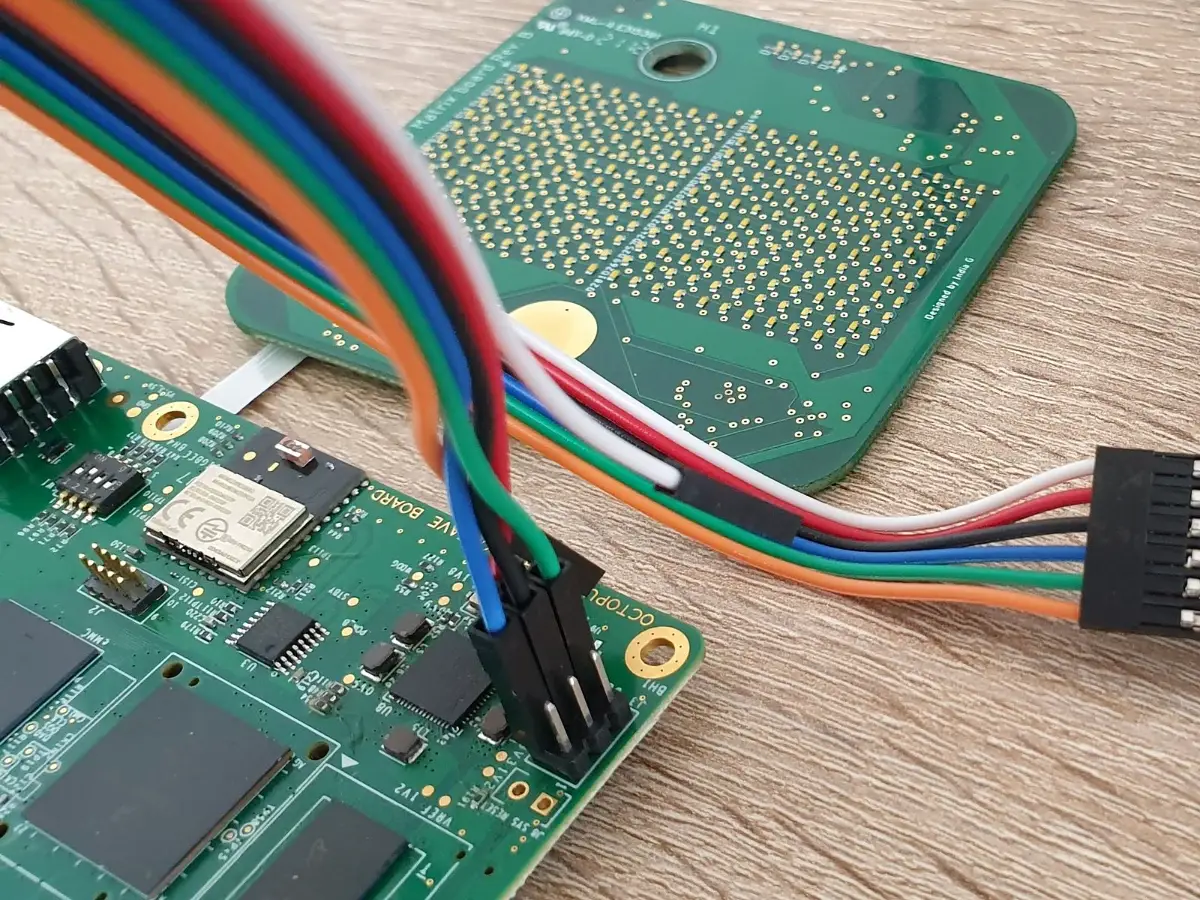 Embedded board on the bench with a serial debug cable connected